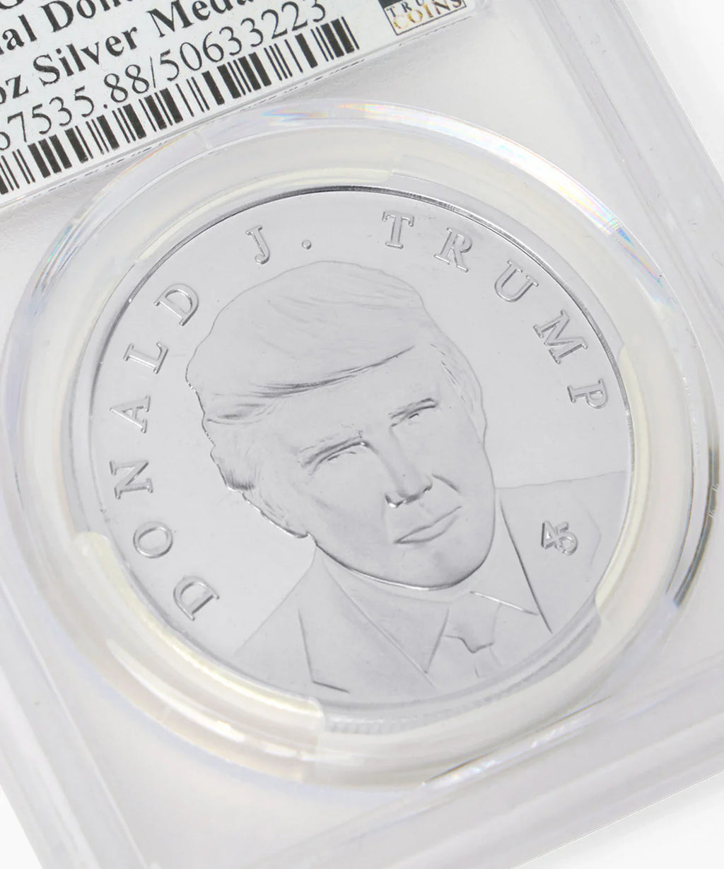 Close-up of Donald J. Trump silver medallion portrait in graded holder