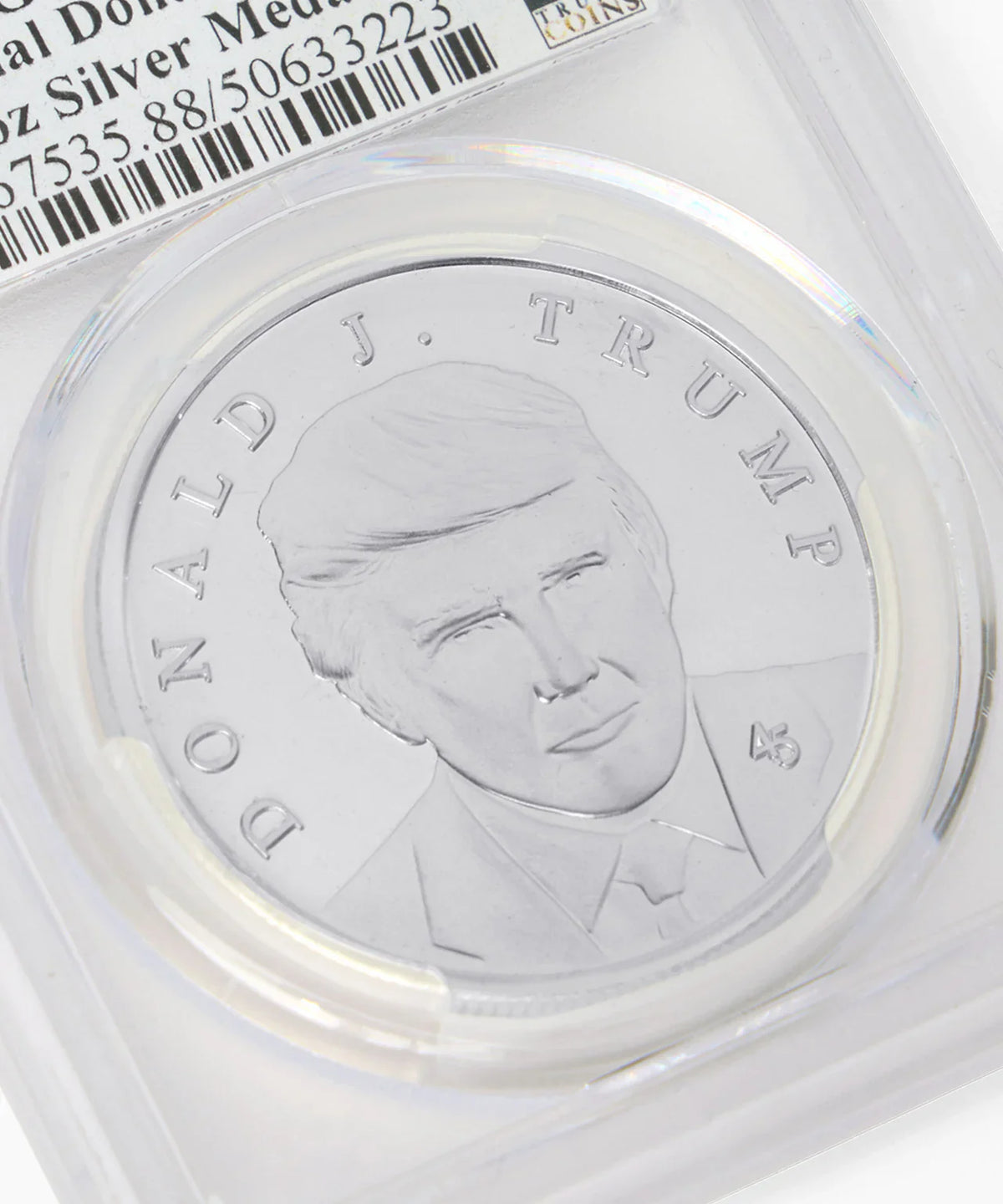 Close-up of Donald J. Trump silver medallion portrait in graded holder