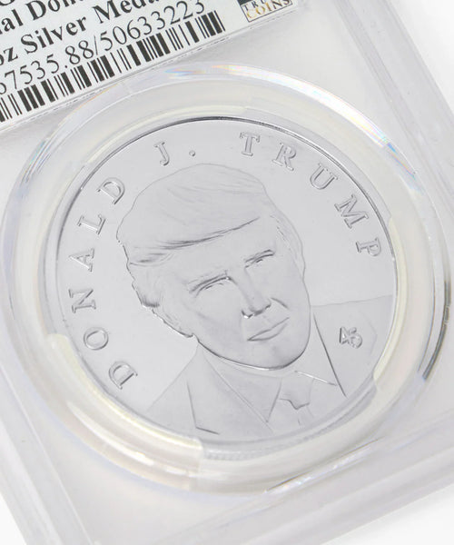 Close-up of Donald J. Trump silver medallion portrait in graded holder