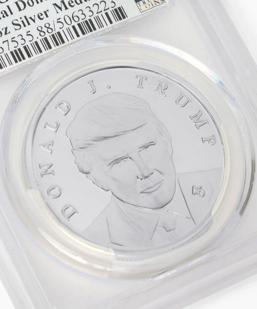 Close-up of Donald J. Trump silver medallion portrait in graded holder
