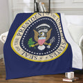 Presidential Seal blanket in navy blue draped over a chair