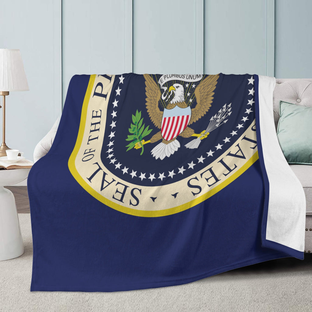 Navy Presidential Seal blanket draped over a sofa