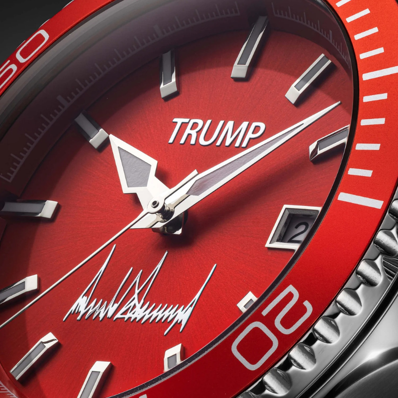 Close-up of Trump red dial watch face with signature and red bezel