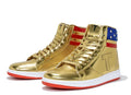 Gold Trump Never Surrender high-top sneakers, angled pair with American flag stars, stripes and T logo