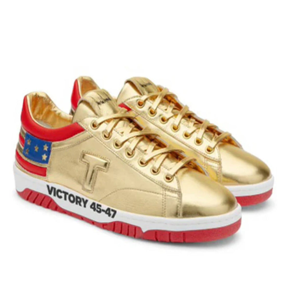 Pair of gold Victory Sneakers with red soles, stars-and-stripes heels and T logo, angled view