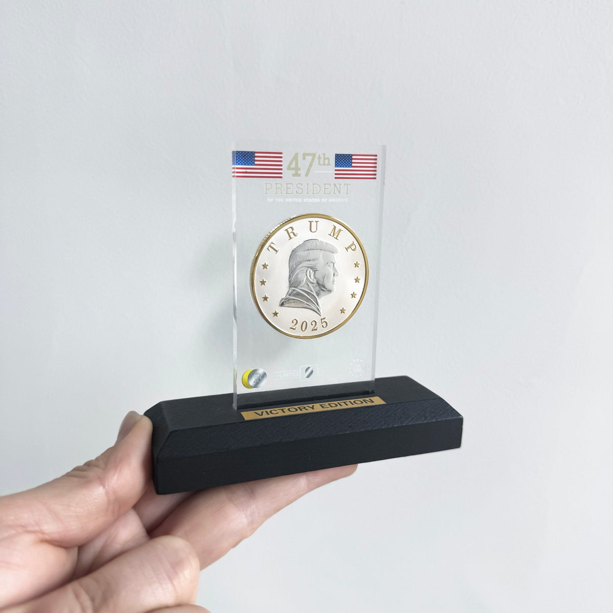 Trump 2025 Victory Edition coin in 47th President acrylic display stand held in hand