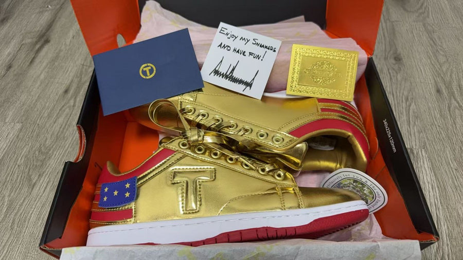 Never Surrender gold low top sneakers in open box with signed card and stars heel