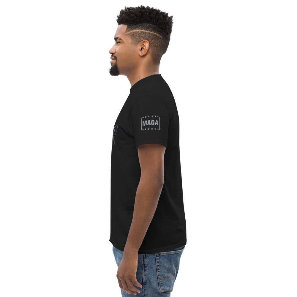 Man wearing black MAGA classic tee, left side showing MAGA sleeve badge
